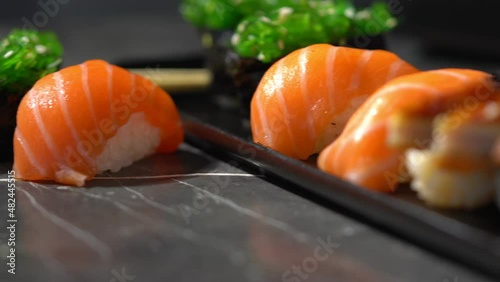 sake sushi, unagi sushi on a serving plate. sushi on a dark background. Japanese food