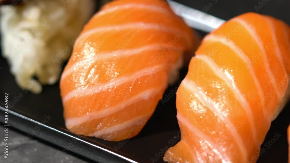 sake sushi, unagi sushi on a serving plate. sushi on a dark background. Japanese food sake sushi, unagi sushi on a serving plate. sushi on a dark background. Japanese food