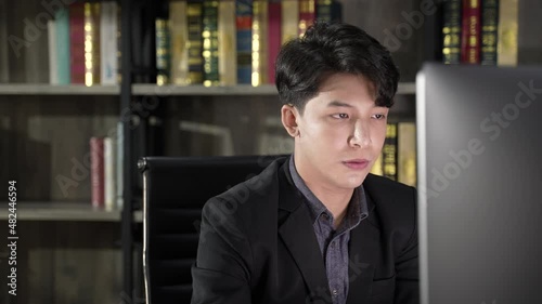 Wallpaper Mural The Toll of Overtime: Young Asian Businessman Experiencing Burnout, Fatigue, and Diminished Efficiency at Work Torontodigital.ca