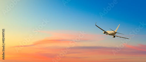  airplane flying above clouds in sunset light photo
