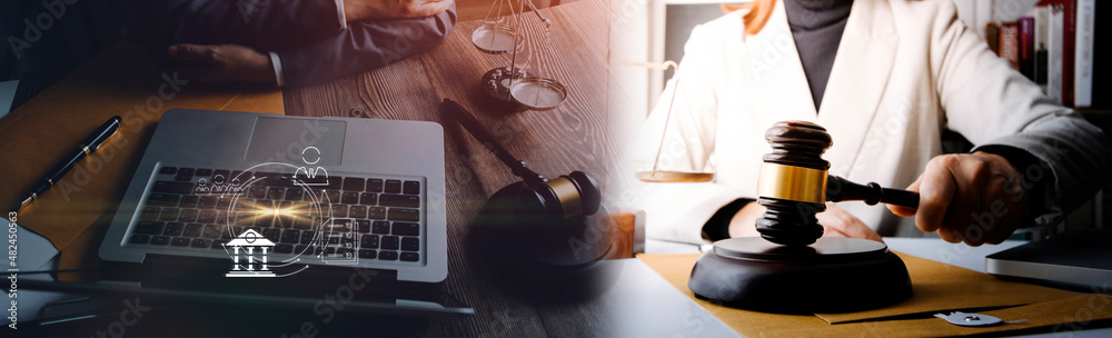 Justice and law concept. Gavel on sounding block in hand's Male judge at a courtroom, working with document law books, report the case on table in modern office. Justice and law concept. Gavel on sounding block in hand's Male judge at a courtroom, working with document law books, report the case on table in modern office.