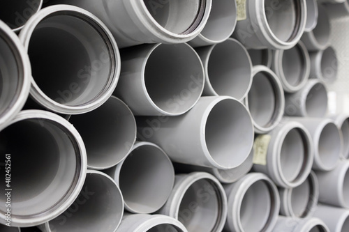  PVC water pipe in storage . Background of plastic pipes . Soft focus