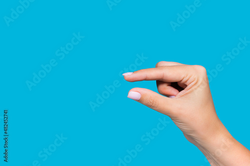 Fototapet Closeup view stock photography  of beautiful white manicured female hand showing