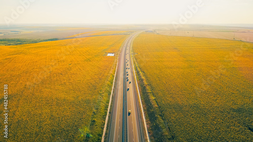 Aerial view of A2 beautiful highway motorway road in Romania through sunflower fields, between Bucharest and Constanta cities. Amazing beautiful road. photo