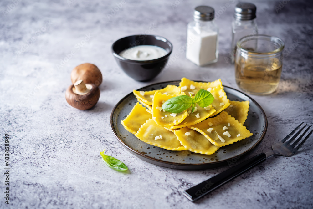 Fresh prepared Ravioli pasta with mushrooms and cheese in a plate Fresh prepared Ravioli pasta with mushrooms and cheese in a plate