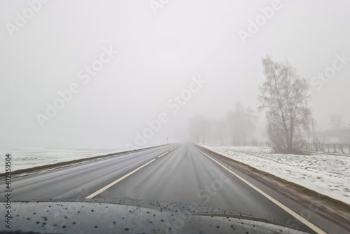 Drive on wet road in heavy fog mist. Lithuania Europe union