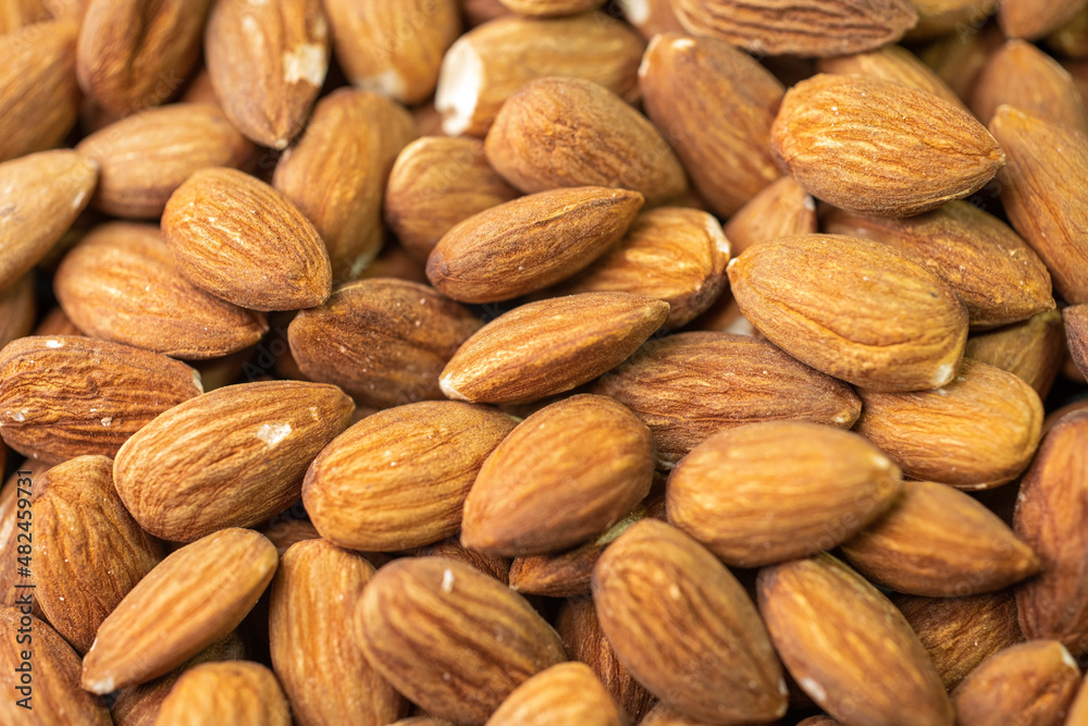 Macro shooting of dry Almond Nuts.Vegetarian food rich in minerals and vitamins. Selective focus Macro shooting of dry Almond Nuts.Vegetarian food rich in minerals and vitamins. Selective focus