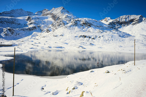 A lover copule skating in a iced lake in Switzerland Alps