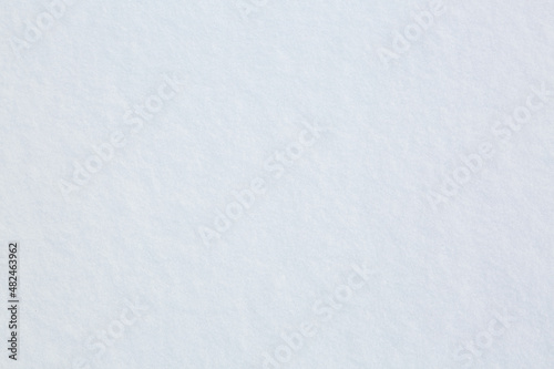 White fluffy snow sparkles in the sun. Texture of freshly fallen snow. Background.