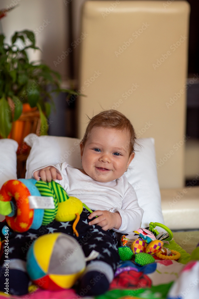 Obraz premium Smiling little girl is playing with baby toy.Little toddler