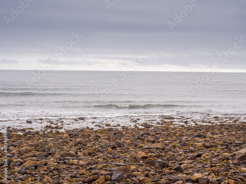 Very stoney beach at Lindisfarne, Holy Island, Northumberland, UK photo
