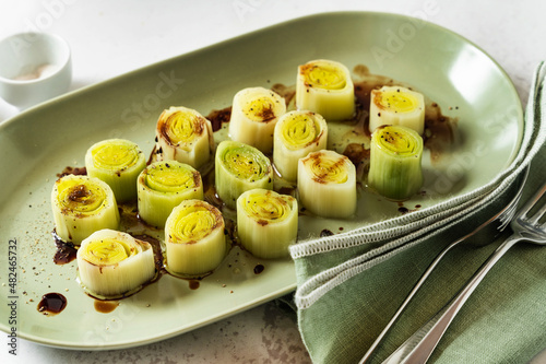 Photos French leek with vinaigrette and balsamic sauce on the table