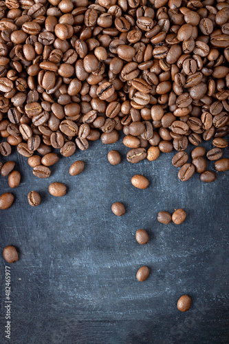 coffee beans scattered over gray background, food background