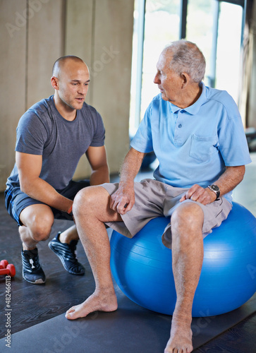 You're getting stronger by the day. Cropped shot of a handsome personal trainer with a senior man.