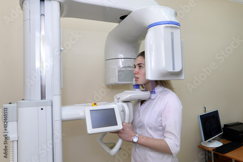 Patient in a dentist's panoramic and cephalometric x-ray system. photo