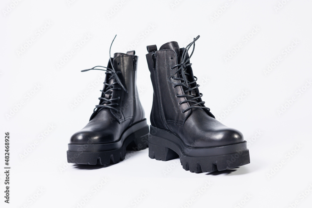 Women's black leather boots on a white background. Shoes and options for its layout. Autumn shoes. Boots. Autumn boots. Shoes close up