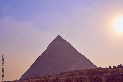 The pyramid of Khafre in a misty haze with ruins in the foreground.