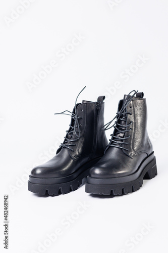 Women's black leather boots on a white background. Shoes and options for its layout. Autumn shoes. Boots. Autumn boots. Shoes close up