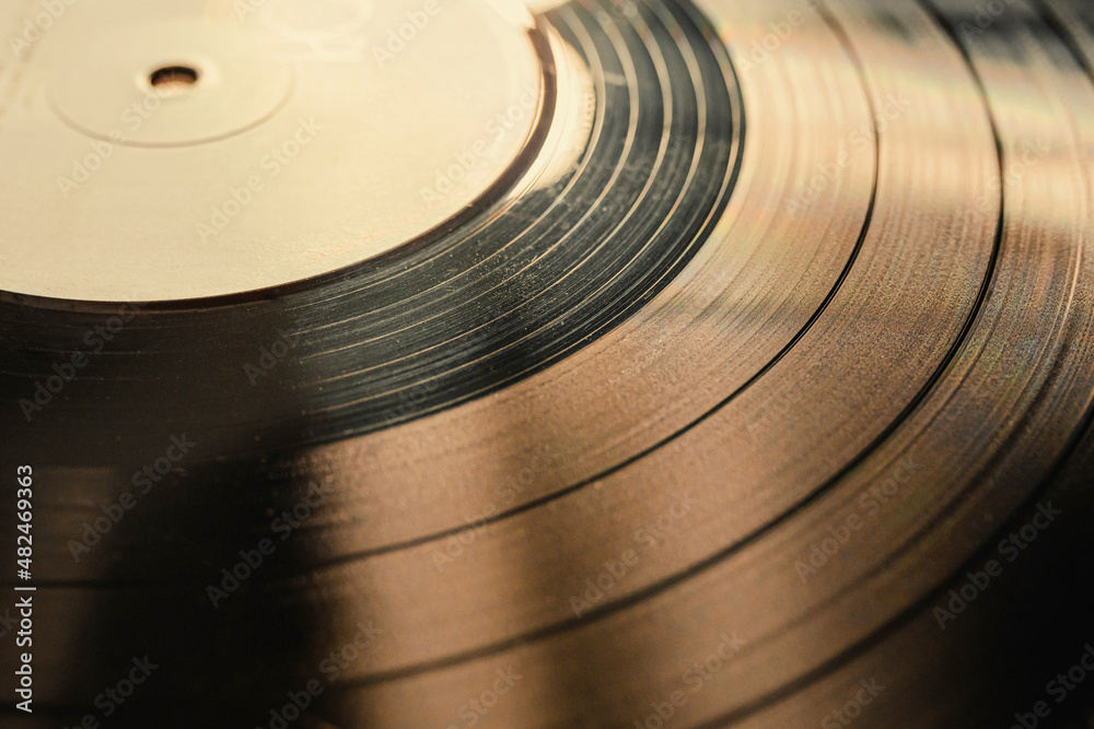 The texture of a vinyl record on a turntable. Photograph of a vinyl record with selective focus The texture of a vinyl record on a turntable. Photograph of a vinyl record with selective focus