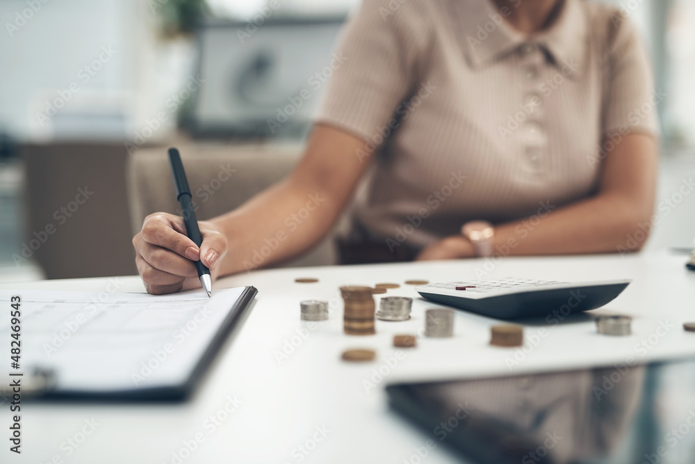 Working on her company's balance sheet. Closeup shot of an unrecognisable businesswoman calculating finances in an office. Working on her company's balance sheet. Closeup shot of an unrecognisable businesswoman calculating finances in an office.