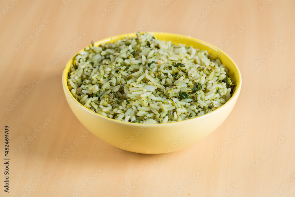 rice with broccoli in yellow bowl on wooden background, in Brazil it's called arroz de brocolis rice with broccoli in yellow bowl on wooden background, in Brazil it's called arroz de brocolis