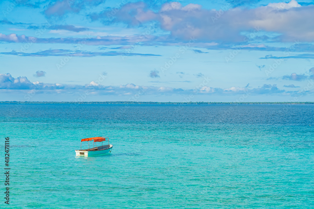 One fishing boat in water of Indian ocean. Zanzibar, Tanzania