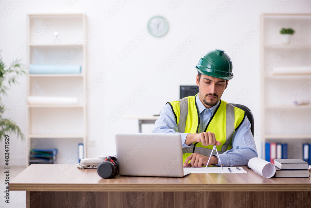 Young male architect working in the office Young male architect working in the office