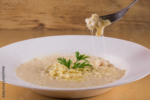 Fork with cheese risotto. Italian cuisine