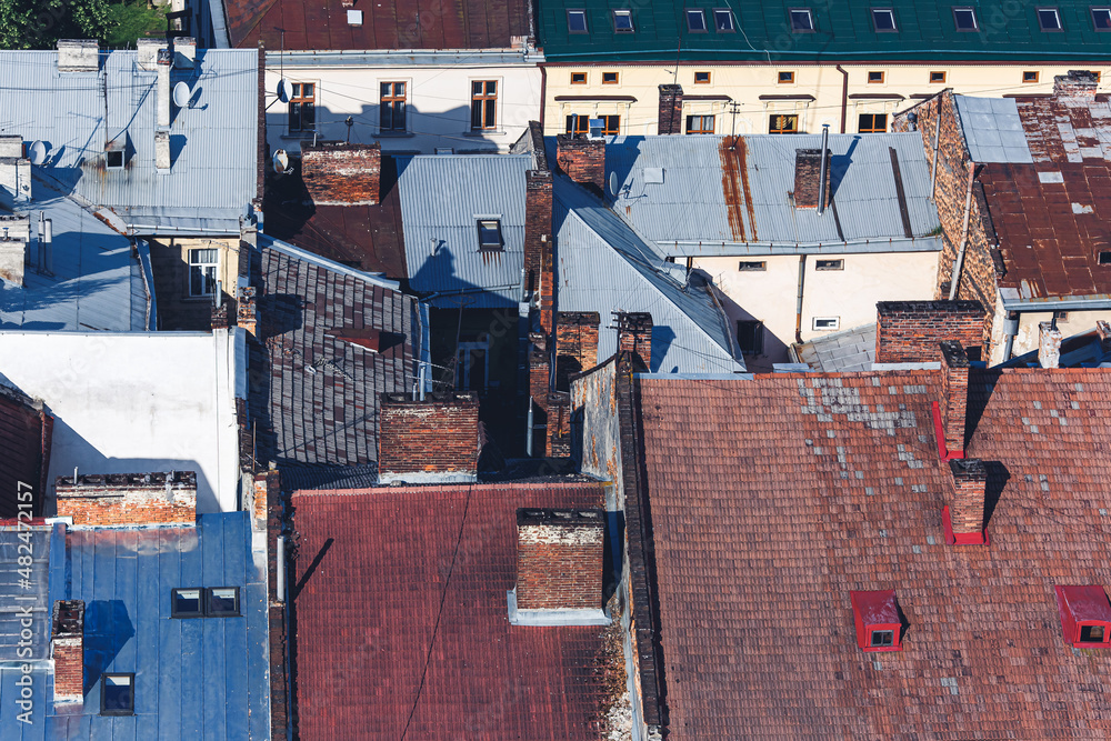 Different types of roofs: iron, roof made of ceramic tiles. Old quarter is viewed from above