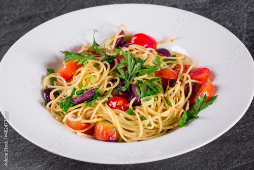 Spaghetti puttanesca. spaghetti with black olives and cherry tomatoes.