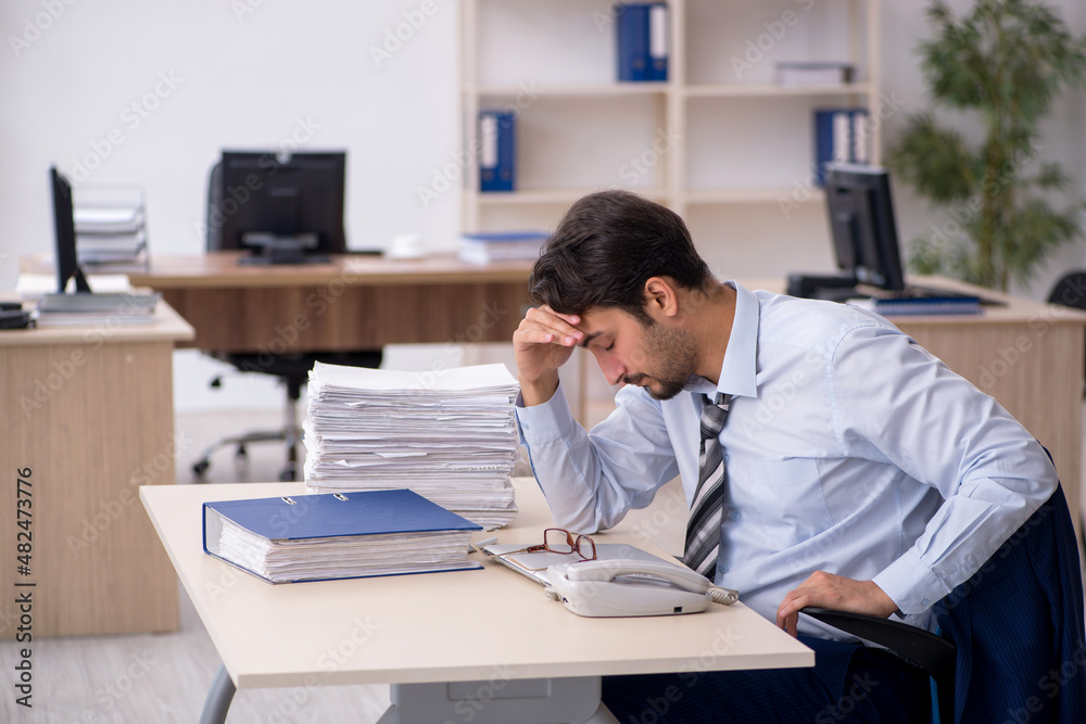 Young male employee working in the office Young male employee working in the office