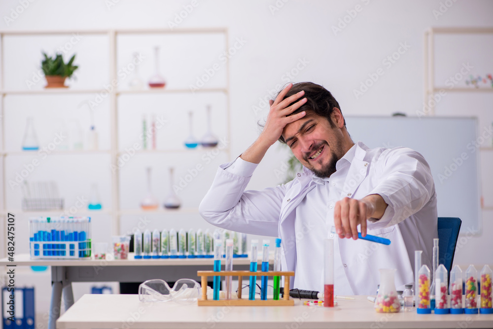 Young male chemist in drugs synthesis concept Young male chemist in drugs synthesis concept