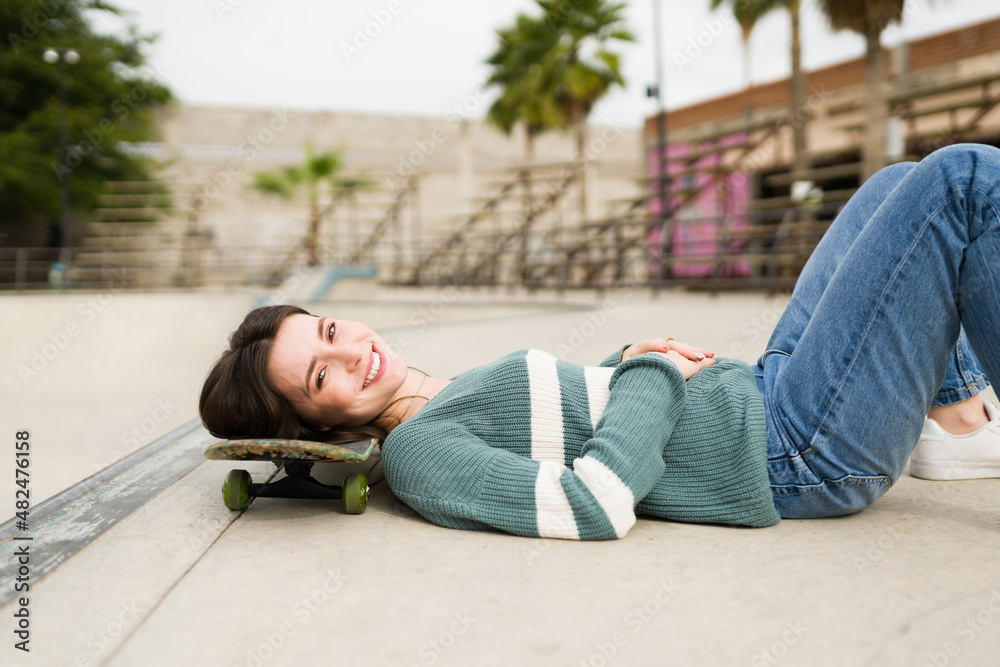 Smiling woman skateboarding Smiling woman skateboarding