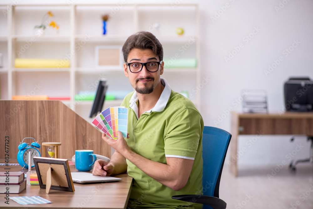 Young male designer working in the office Young male designer working in the office