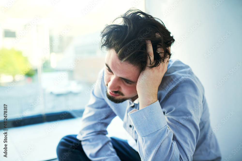 Held captive by his conscious. Shot of a young man suffering from a mental breakdown. Held captive by his conscious. Shot of a young man suffering from a mental breakdown.