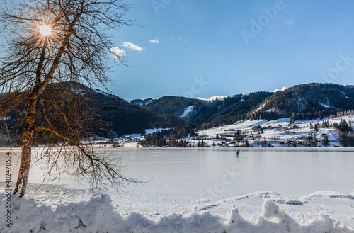 ice skater on the frozen Weissensee lake in Austria