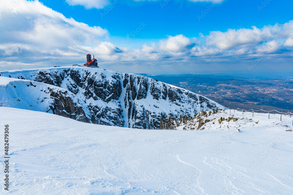 Fototapeta premium Snowy landscape of mountain trails and hills at cloudy morning