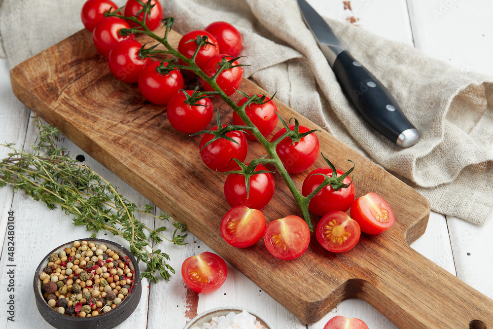 Fresh red cherry tomatoes on white wooden background Fresh red cherry tomatoes on white wooden background