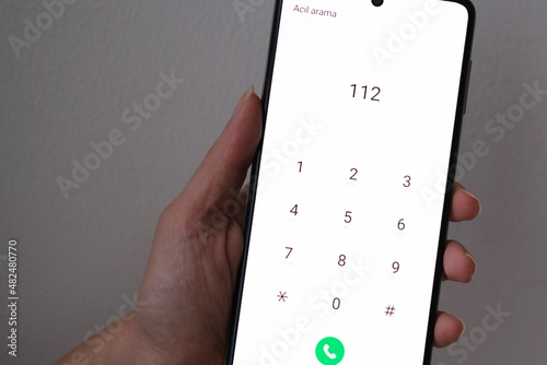 Woman calling 112 for an emergency. It says 