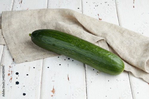 Fresh cucumber on white wood table