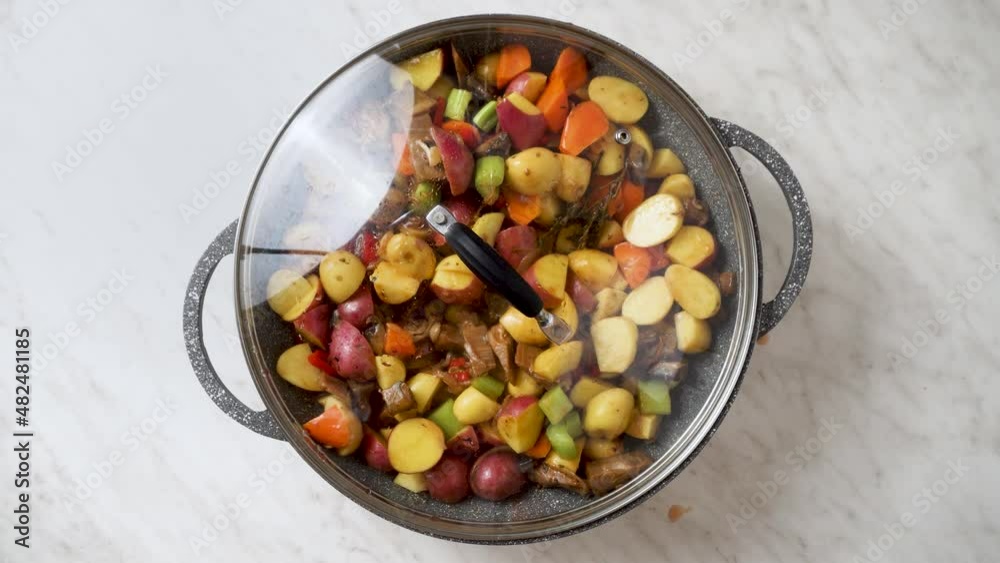 cook vegan stir-fry with vegetables, mushrooms and potatoes cook vegan stir-fry with vegetables, mushrooms and potatoes