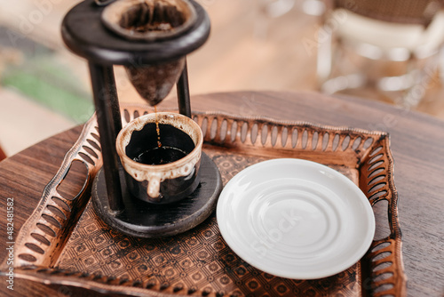 Coffee made in an artisan way, served at the customer's table photo