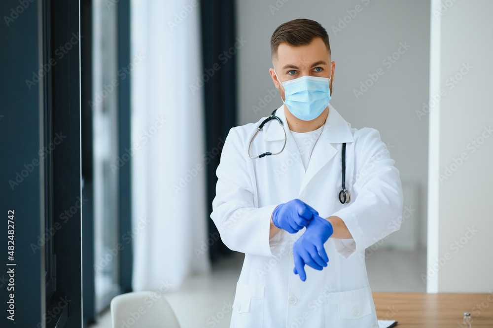 Portrait of male doctor wearing surgical mask is ready to help patients with coronavirus or covid virus.