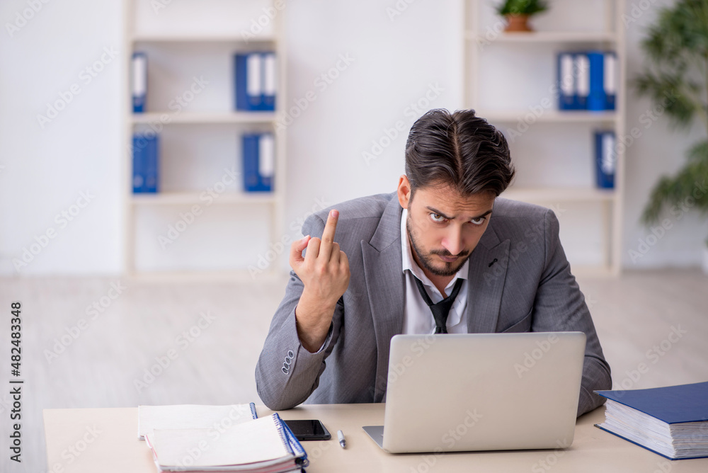 Young male employee working in the office