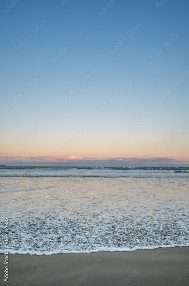 Beach Sunset Over the Waves at Orewa, Auckland New Zealand