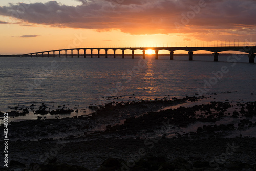 Re island bridge at sunset on a sunny evening. beautiful colors. view from La Rochelle, France © mathilde