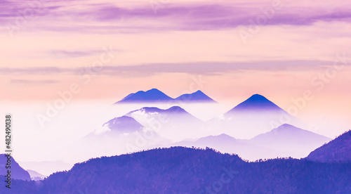 Peaceful image of calm landscape with blue mountains and pale sky