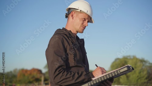 Roofing project manager supervising a flat roof build