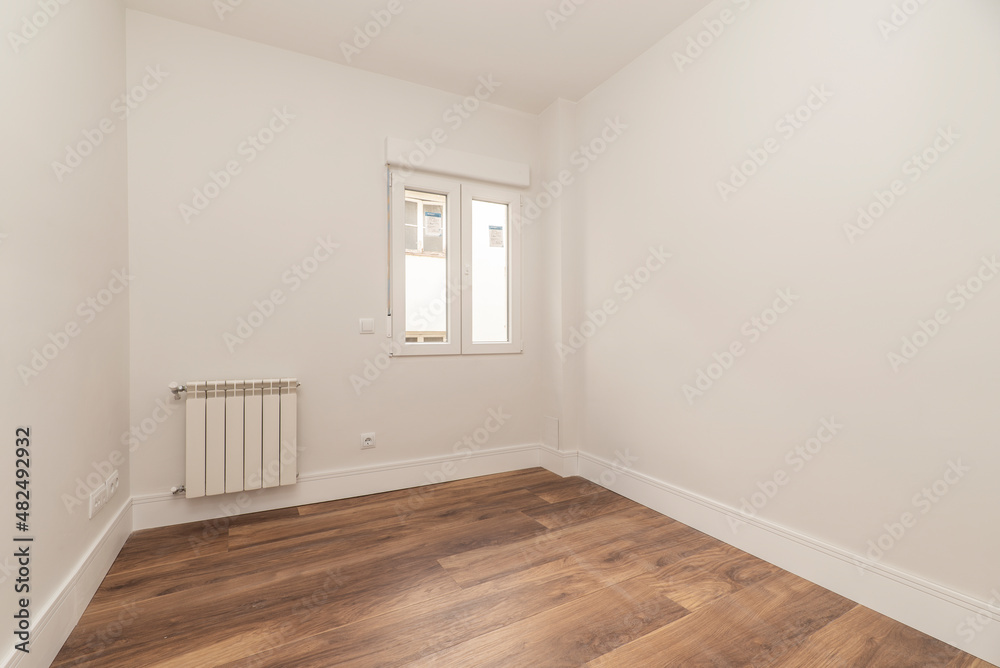 Fototapeta premium Empty residential building room with white painted aluminum radiator and dark parquet floor