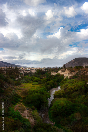 Landscape with a river, trees and clouds in Mitad del Mundo, Ecuador